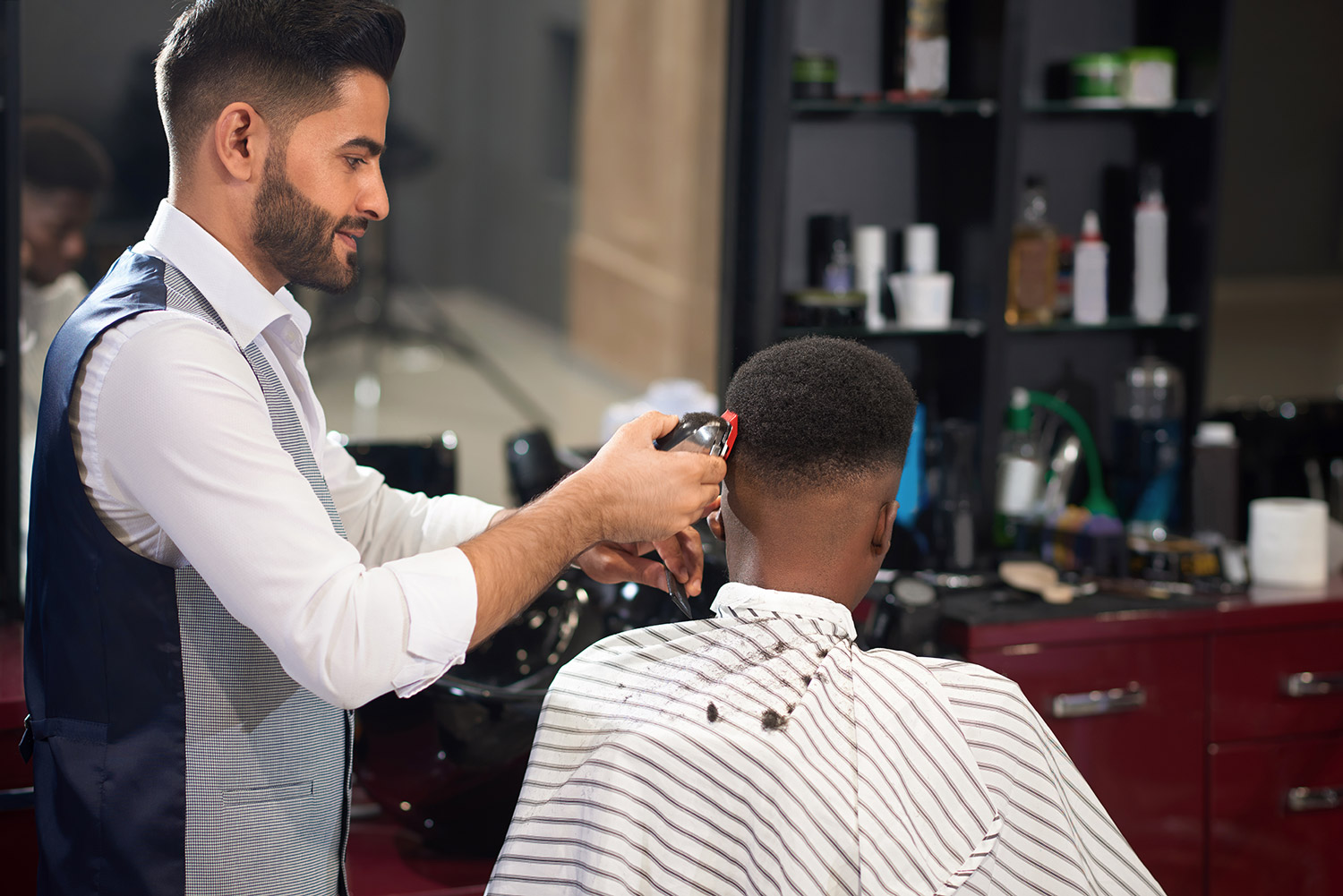 barber-trimming-hair-male-with-clipper-barber-shop